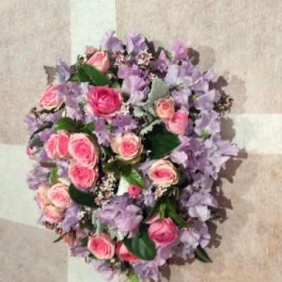 Pretty Pastels - Roses, sweet peas , Ranunculas , Eriostomen,and Dusty Miller in assorted pastel tones styled as a hand tied natural stem posy or created in an arrangement in glass or ceramic. Substitute to bright colours upon request .