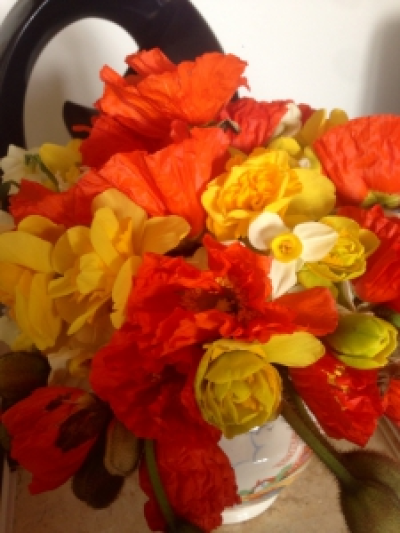 Spring sensation - Bright and vibrant orange poppies , daffodils and jonquils arranged in a natural stem posy. Flower Varietiea may vary due to seasonal availability.