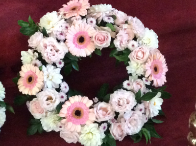 Softly serene - Floral wreath of an assortment of seasonal soft pink pastel flowers.