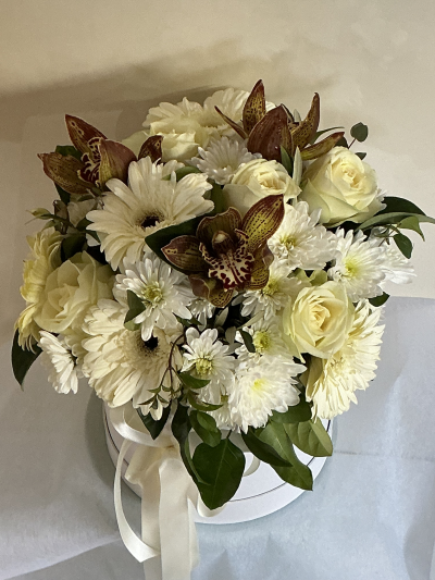 Graceful Beauty - Seasonal white flowers arranged in a hat box with the inclusion of seasonal orchids.(colour theme upon request)