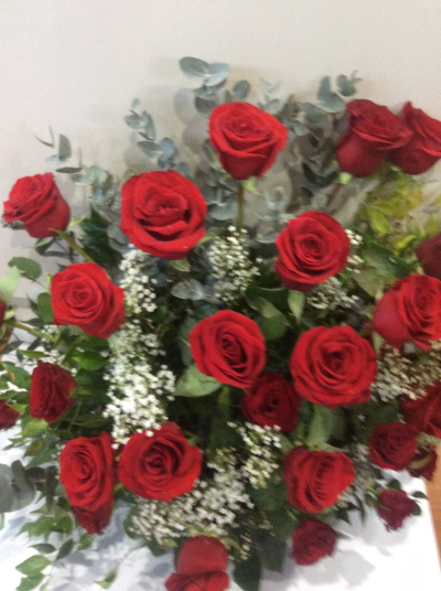 Trueness - Front facing arrangement of all roses with a mixture of foliage and a transitional flower to compliment the roses.